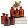 Farmlyn Creek 6-Pack Small Amber Vases for Centerpieces, Brown Glass Vase Bottles for Stems, Flower Buds, Apothecary Style Home Decor (2.8x5 in)